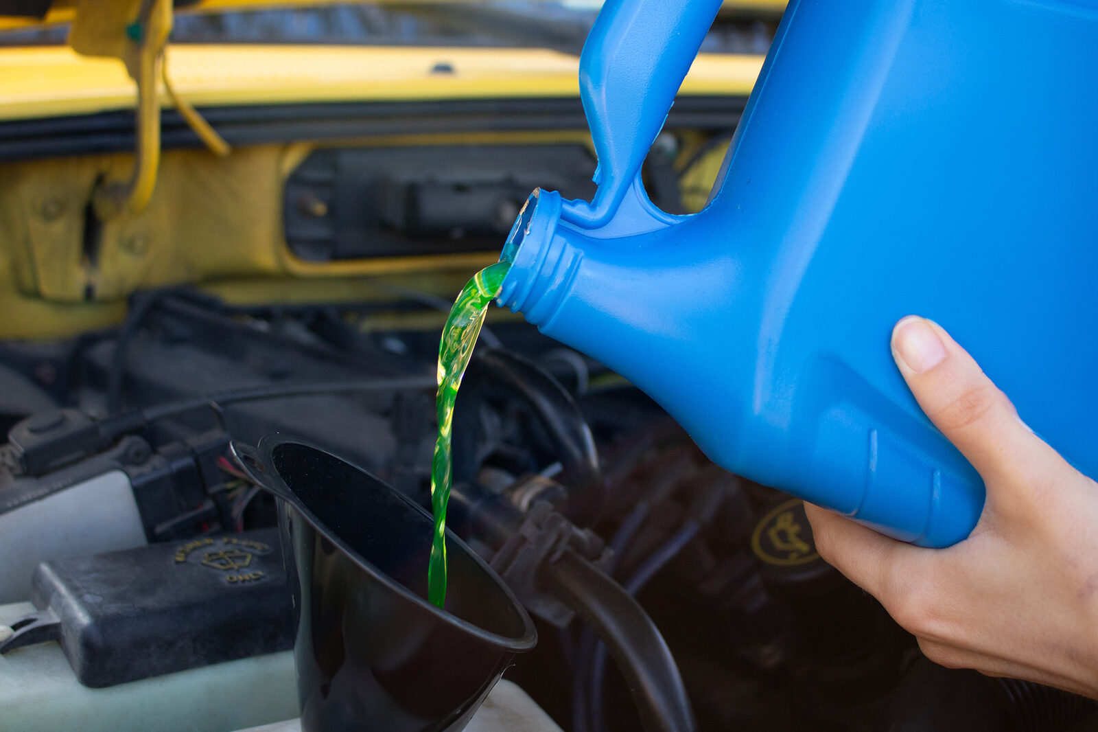 Antifreeze coolant being poured into an engine